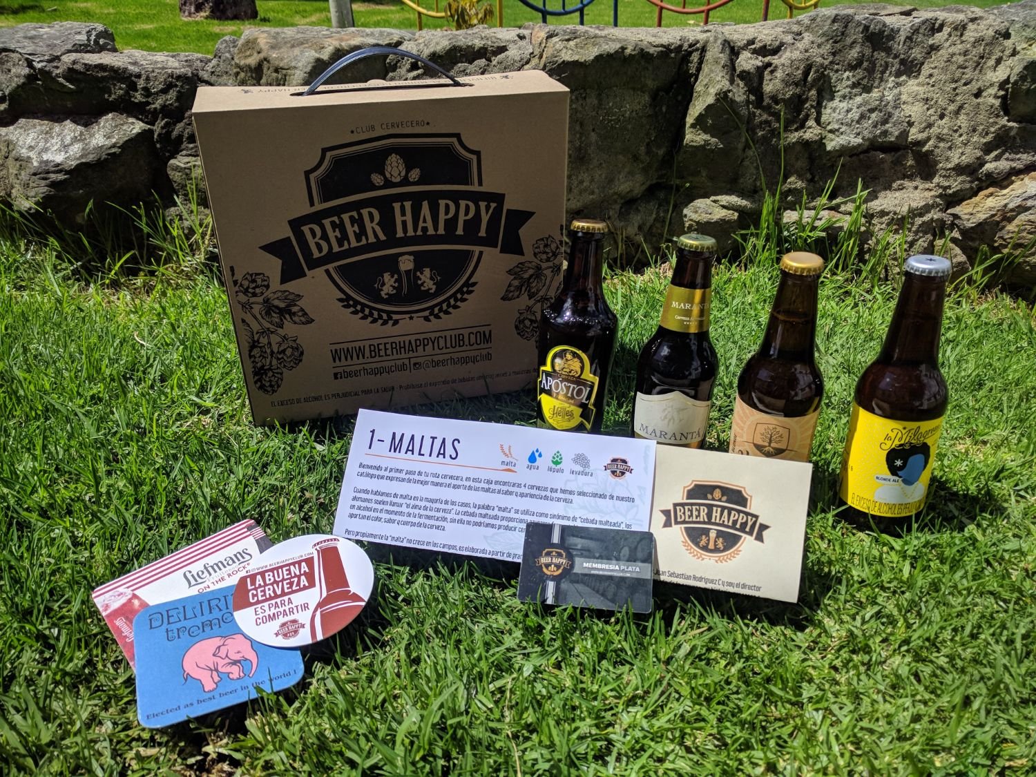 A Beer Happy Club box with four craft beers, a tasting guide and a membership card